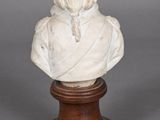 a white marble bust of a woman on a wooden base