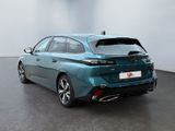 the rear end of a blue car parked in a room
