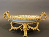 an ornate gold and blue tray with a bird on it