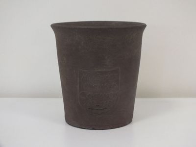 une tasse noire posée sur une table blanche