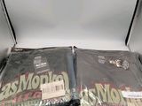 two bags of magazines sitting on top of a white table