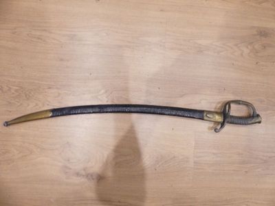 a sword on a table with a shadow on the floor
