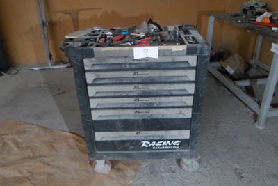 a tool cart with many tools on it in a garage