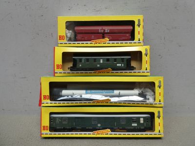 three boxes of toy trains are stacked on top of each other