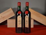 two bottles of wine sitting next to each other on a table