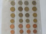 a lot of different coins in a bag on the table