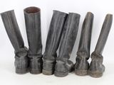five pairs of black leather boots lined up against a white background