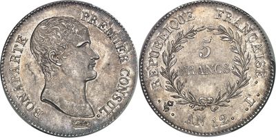 a silver coin with the head of a woman in profile