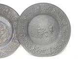 these are two plates with designs on them on a white surface