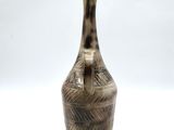 an image of a brown and black vase on a white background