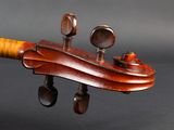 an antique violin with a wooden back and a wooden neck