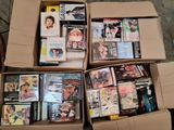 un grand nombre de dvd dans une boîte posée sur le sol