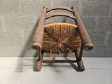 a wooden chair with a straw seat on it