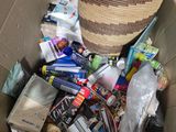 a cardboard box filled with assorted items on the floor
