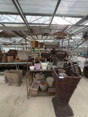many baskets and baskets on display inside of a greenhouse