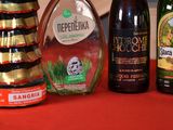 several bottles of alcohol are lined up on a red table