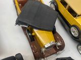 several toy cars are lined up on a white surface