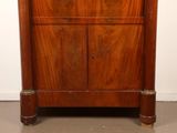 a wooden cabinet with a mirror on top of it