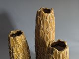 three vases that are sitting next to each other on a table