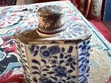 a blue and white container with a lid on a table