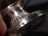 a person that is holding a silver object in their hand