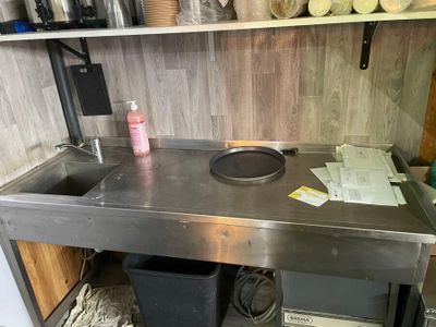 a kitchen with a sink and a stove in it