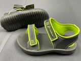 a pair of children ' s sandals on a gray surface