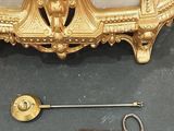 a gold plate with a key and a keychain