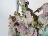 a figurine of a group of people sitting under a tree