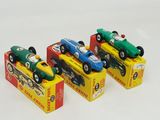 three toy cars sitting in a row on a white surface