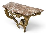 an antique console table with a marble top and ornate carvings
