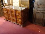 a dresser with a mirror on top of it in the middle of a room