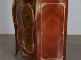 an antique wooden cabinet with a mirror on top of it