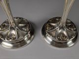 pair of silver plated candlesticks with ornate design
