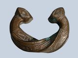 a bronze sculpture of a fish on a blue background