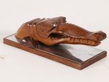 wooden sculpture of an elephant on a marble base on a white background