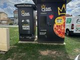 a pizza oven that is next to a parking lot