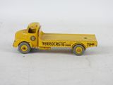yellow toy truck sitting on a white surface with a white background