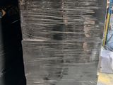 a large stack of black plastic sheets stacked on top of each other