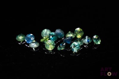 a close up of a group of gems on a black surface