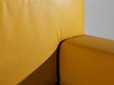 a close up of a yellow couch with a white background