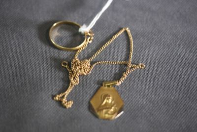 a gold ring and a gold chain with a gold pendant on it