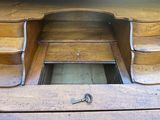 a wooden desk with a key on top of it