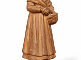an old wooden statue of a woman holding a basket