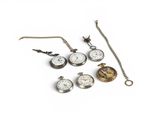 many different types of pocket watches on a white surface