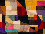 an image of a multicolored rug with squares and rectangles