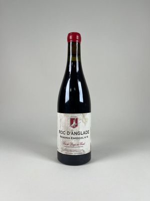 the bottle of red wine is sitting on the table