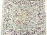 a close up of a floral print scarf on a white surface