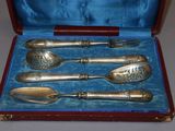 four spoons and a fork in a case