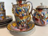 three cups and saucers sitting on a table
